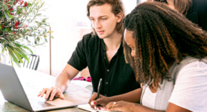 man and woman using laptop